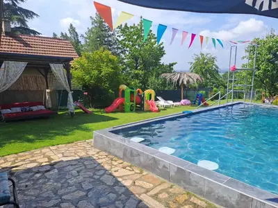a swimming pool in a yard with a playground at Sava Land in Belgrade
