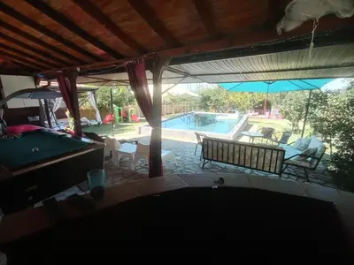 a pool table in a living room next to a swimming pool at Sava Land in Belgrade
