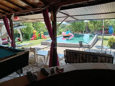 a backyard pool with a pool table and a pool table at Sava Land in Belgrade