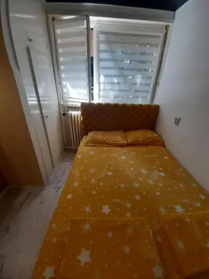 a small bedroom with a bed with stars on it at Apartman brdo in Belgrade
