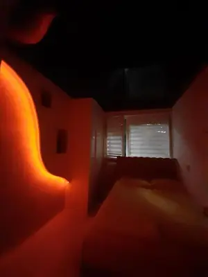 a dark room with a bed and a window at Apartman brdo in Belgrade