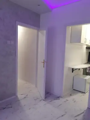 an empty room with a white door and a table at Apartman brdo in Belgrade