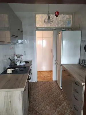 a kitchen with a refrigerator and a counter top at Sobe AURORA Nehruova 82 in Belgrade