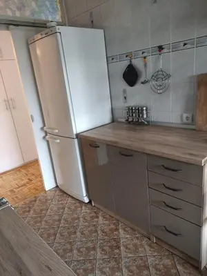a kitchen with a white refrigerator and a counter at Sobe AURORA Nehruova 82 in Belgrade