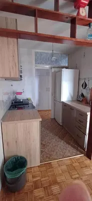 a kitchen with a counter top and a refrigerator at Sobe AURORA Nehruova 82 in Belgrade