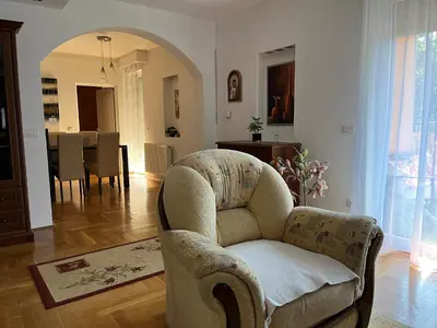a living room with a chair and a dining room at Luxury Apartment in Mladenovac