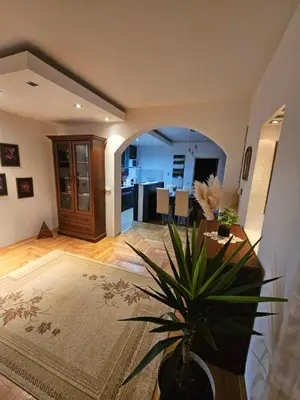 a living room with a table and a potted plant at Luxury Apartment in Mladenovac