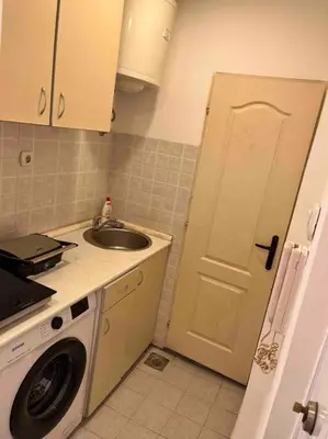 a kitchen with a sink and a washing machine at Central Home in Belgrade in Belgrade