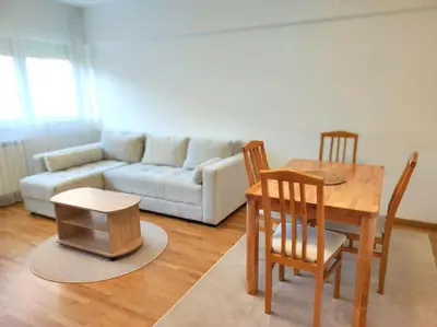 a living room with a table and a couch at Magenta New Belgrade in Belgrade