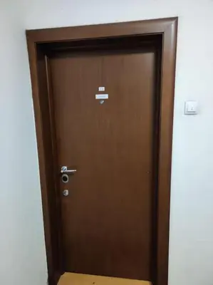 a wooden door in a room with at Magenta New Belgrade in Belgrade