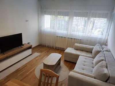 a living room with a couch and a tv at Magenta New Belgrade in Belgrade