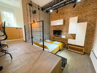 a bedroom with a bed and a brick wall at Downtown Heaven in Belgrade