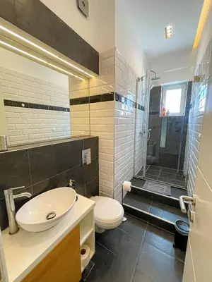 a bathroom with a sink and a toilet and a shower at Downtown Heaven in Belgrade