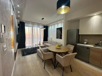 a kitchen and living room with a table and chairs at THE GATES 210 in Belgrade