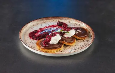 a plate of food on a table with dessert at THE GATES 210 in Belgrade