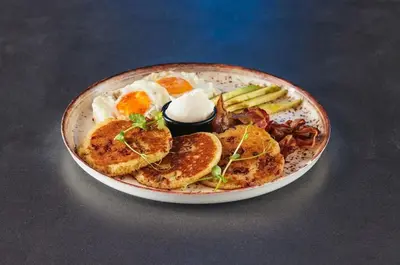 a plate of food with eggs and vegetables on a table at THE GATES 210 in Belgrade
