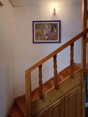 a painting hanging on a wall next to a staircase at Maravilja in Filmski Grad