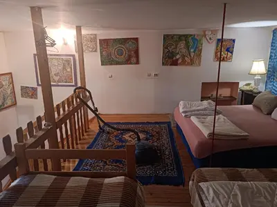 a living room with two beds and a table at Maravilja in Filmski Grad