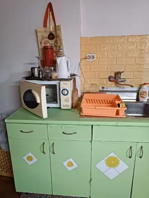 a kitchen with a green cabinet with a microwave on it at Maravilja in Filmski Grad