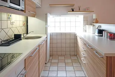 a small kitchen with a sink and a counter at Red Tree Apartment in Belgrade