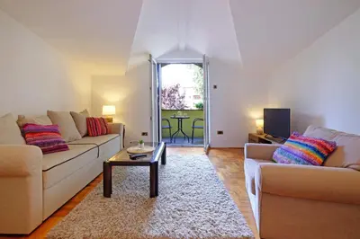 a living room with two couches and a table at Red Tree Apartment in Belgrade
