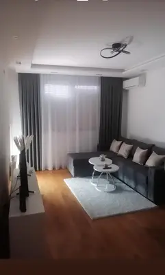 a living room with a couch and a table at Apartman Maja in Ruma