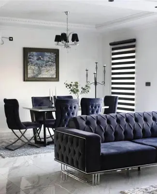 a living room with a black couch and a table at Vila Grof in Vinča