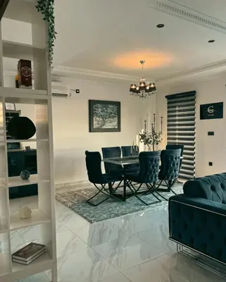 a living room with a table and chairs at Vila Grof in Vinča