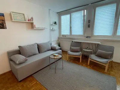 a living room with a couch and two chairs at Apartman Vuković in Novi Beograd