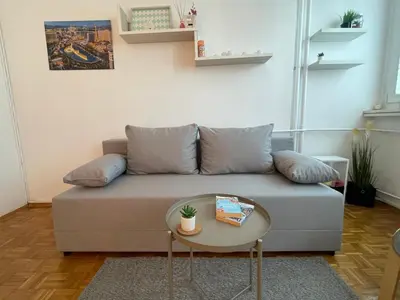 a living room with a couch and a table at Apartman Vuković in Novi Beograd