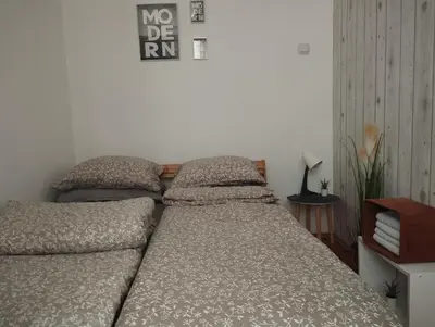 a bed with two pillows on it in a bedroom at Apartman Vuković in Novi Beograd