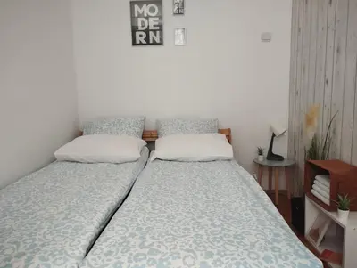 a bed in a room with two pillows on it at Apartman Vuković in Novi Beograd