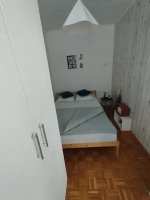 a small bedroom with a bed in a room at Apartman Vuković in Novi Beograd