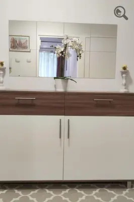 a bathroom counter with a vase of flowers on it at Astra M in Vračar (historical)