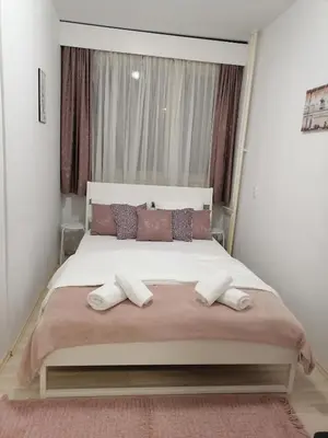 a bedroom with a large bed with two pillows at Astra M in Vračar (historical)