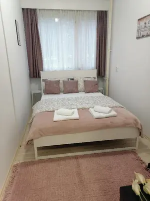 a bedroom with a large bed with two towels on it at Astra M in Vračar (historical)