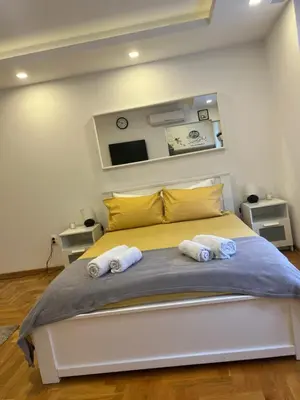 a bedroom with a bed with two towels on it at Tesla View Apartment in Belgrade