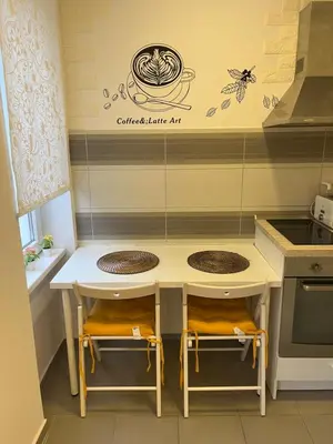 a small kitchen with a table and two chairs at Tesla View Apartment in Belgrade