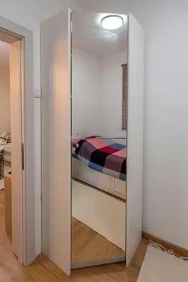 a mirror in a bedroom with a bed in it at 1-bedroom apartment near airport in Surčin