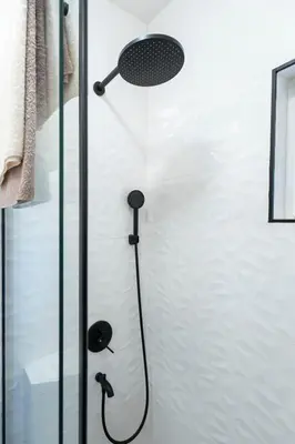 a shower with a shower head in a bathroom at 1-bedroom apartment near airport in Surčin