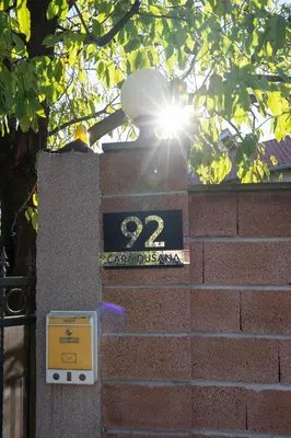 a sun shining behind a sign on a brick wall at 1-bedroom apartment near airport in Surčin