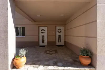 a hallway with two doors and two potted plants at 1-bedroom apartment near airport in Surčin