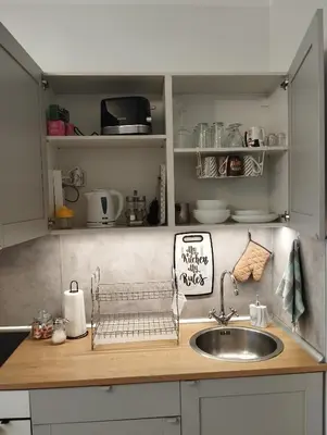 a kitchen counter with a sink and a sink at Manila Apartment in Belgrade