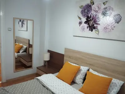 a bedroom with a bed and a mirror at Manila Apartment in Belgrade