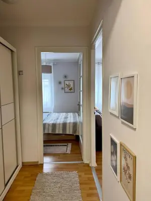 a hallway with a bedroom with a bed in it at Manila Apartment in Belgrade