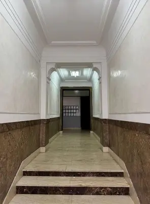 an empty hallway with stairs in a building at Manila Apartment in Belgrade