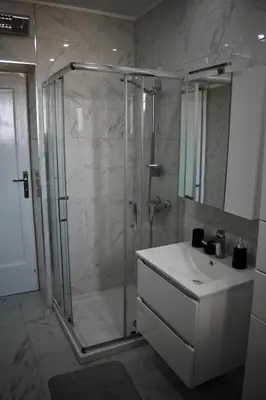 a bathroom with a shower and a sink and a shower at Manila Apartment in Belgrade