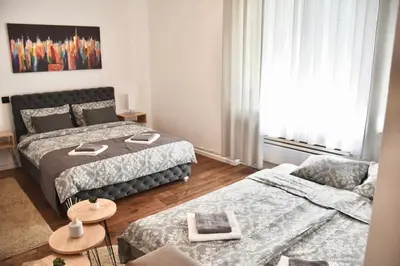 a living room with two beds and a couch at Apartment in Belgrade with small parking space in Belgrade