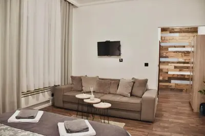 a living room with a couch and two tables at Apartment in Belgrade with small parking space in Belgrade