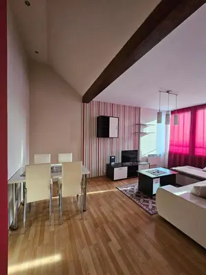a living room with a dining table and a couch at Belgrade Loft Apartments in Novi Beograd